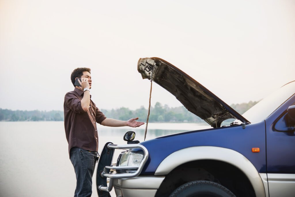 Man try to fix a car engine problem on a local road Chiang mai Thailand - people with car problem transportation concept